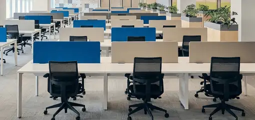 Modern open-plan office space featuring clean workstations, ergonomic chairs, and sanitized carpets provided by professional office cleaning services in Kansas City, MO.