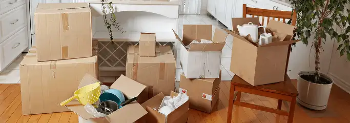 Packed moving boxes and household items in a kitchen before move-out or move-in cleaning, Kansas City, MO.